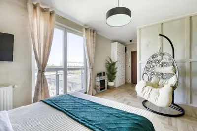 Łóżko lub łóżka w pokoju w obiekcie Palladium Elektoralna Apartments