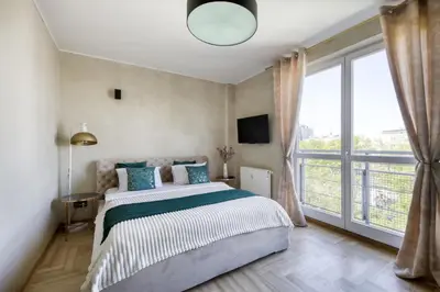 Łóżko lub łóżka w pokoju w obiekcie Palladium Elektoralna Apartments