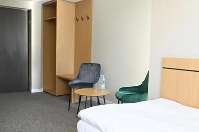 Łóżko lub łóżka w pokoju w obiekcie Hotel Parrot