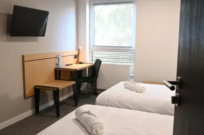Łóżko lub łóżka w pokoju w obiekcie Hotel Parrot