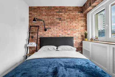Łóżko lub łóżka w pokoju w obiekcie Vistula Loft Blue Apartment by BookingHost
