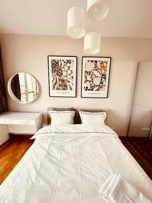 Łóżko lub łóżka w pokoju w obiekcie Jardin Apartment Ursynów