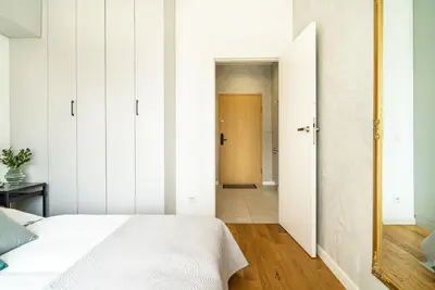 Łóżko lub łóżka w pokoju w obiekcie ApartamentySnu, Wola Premium II z parkingiem