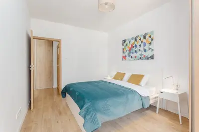 Łóżko lub łóżka w pokoju w obiekcie Warsaw In City Apartments