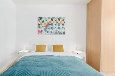 Łóżko lub łóżka w pokoju w obiekcie Warsaw In City Apartments