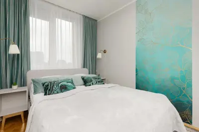 Łóżko lub łóżka w pokoju w obiekcie Cozy Two-Bedroom Apartment Mokotow by Noclegi Renters