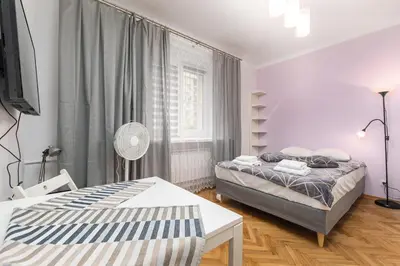 Łóżko lub łóżka w pokoju w obiekcie Szymanowskiego 4 by Homeprime
