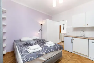 Łóżko lub łóżka w pokoju w obiekcie Szymanowskiego 4 by Homeprime