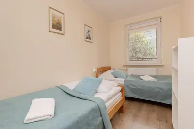 Łóżko lub łóżka w pokoju w obiekcie Dickens St Apartment Warsaw by Noclegi Renters