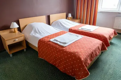 Łóżko lub łóżka w pokoju w obiekcie Hotel Wilanów