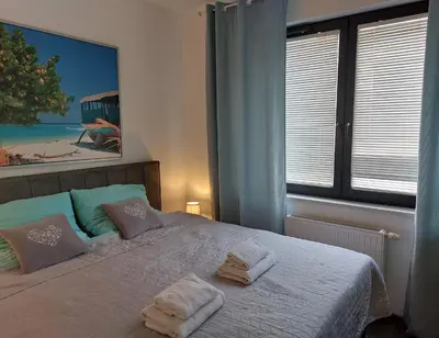 Łóżko lub łóżka w pokoju w obiekcie Apartament JK 47 A z miejscem postojowym w garażu