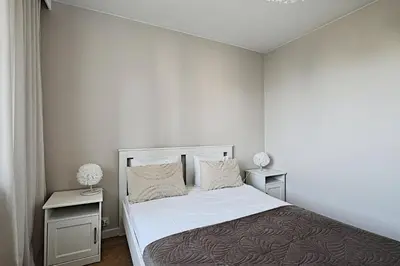 Łóżko lub łóżka w pokoju w obiekcie Metropolitan Heaven Apartment Emilii Plater 55