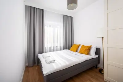 Łóżko lub łóżka w pokoju w obiekcie Park Skaryszewski Cosy Apartment by BookingHost