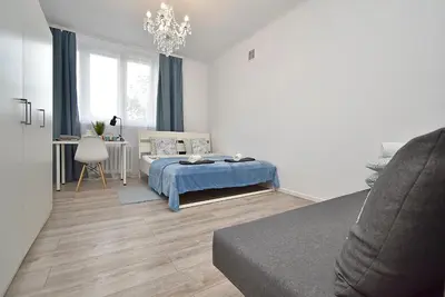 Łóżko lub łóżka w pokoju w obiekcie Rental Apartments Aleja Niepodległości