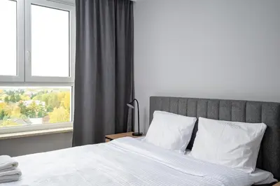 Łóżko lub łóżka w pokoju w obiekcie Wiktoryn Comfortable Two-Room Apartment by BookingHost