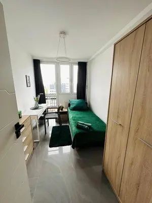 Łóżko lub łóżka w pokoju w obiekcie Warsaw City Center Rooms