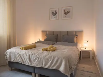 Łóżko lub łóżka w pokoju w obiekcie Apartament Clever 1 Kamienica Grochów