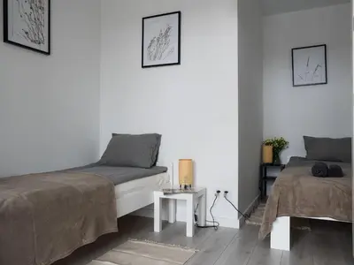 Łóżko lub łóżka w pokoju w obiekcie Apartament Clever 2 Kamienica Grochów