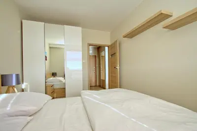 Łóżko lub łóżka w pokoju w obiekcie City Apartments Jaktorowska