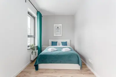 Łóżko lub łóżka w pokoju w obiekcie Warsaw City Apartments Praga