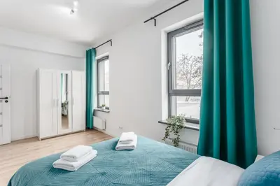 Łóżko lub łóżka w pokoju w obiekcie Warsaw City Apartments Praga