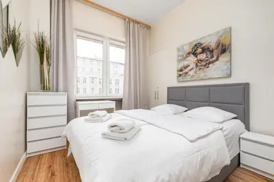 Łóżko lub łóżka w pokoju w obiekcie Apartamenty Wawa Centrum by Your Freedom