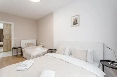 Łóżko lub łóżka w pokoju w obiekcie Warsaw City Family Premium