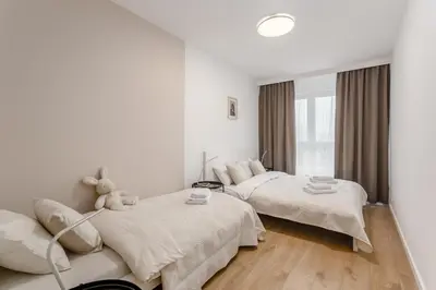 Łóżko lub łóżka w pokoju w obiekcie Warsaw City Family Premium
