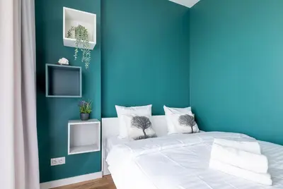 Łóżko lub łóżka w pokoju w obiekcie RentPlanet - Apartamenty Kasprzaka