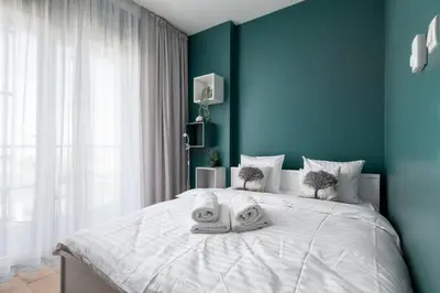 Łóżko lub łóżka w pokoju w obiekcie RentPlanet - Apartamenty Kasprzaka