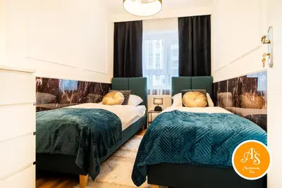 Łóżko lub łóżka w pokoju w obiekcie ApartamentySnu, Wola Komfort IV z parkingiem
