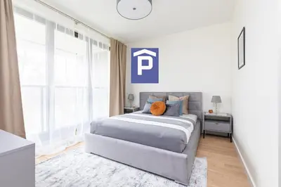 Łóżko lub łóżka w pokoju w obiekcie SuperApart Stanisława Augusta apt 42 - Park Skaryszewski