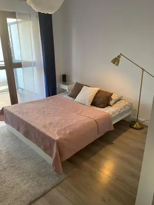 Łóżko lub łóżka w pokoju w obiekcie Apartament JANA KAZIMIERZA 66