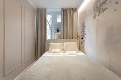 Łóżko lub łóżka w pokoju w obiekcie Grzybowska Rooms by Sofija