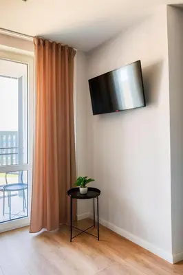 Telewizja i/lub zestaw kina domowego w obiekcie OstWest Apartments