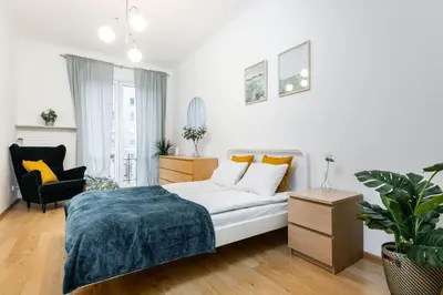Łóżko lub łóżka w pokoju w obiekcie Coriander Apartment City Center