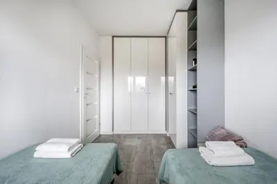 Łóżko lub łóżka w pokoju w obiekcie Gama Home Glebocka 5D, 2-6 Guests