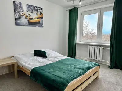 Łóżko lub łóżka w pokoju w obiekcie Apartament Stadion naprzeciwko Stadionu Narodowego w Warszawie