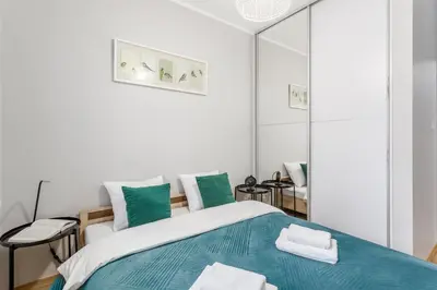 Łóżko lub łóżka w pokoju w obiekcie Warsaw In City Apartments II