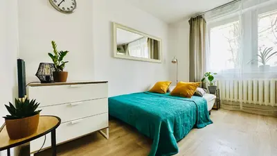 Łóżko lub łóżka w pokoju w obiekcie Cosy Stay Muranów