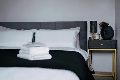 Łóżko lub łóżka w pokoju w obiekcie JP Centre Apartment