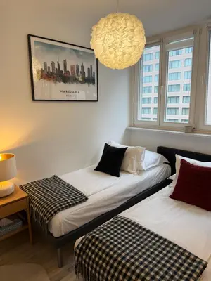 Łóżko lub łóżka w pokoju w obiekcie Apartament Centrum Warszawy Pereca