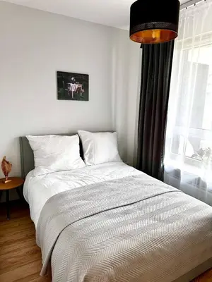 Łóżko lub łóżka w pokoju w obiekcie Apartament Jutrzenki