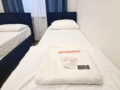 Łóżko lub łóżka w pokoju w obiekcie Apart HoStel Helvetia B&B