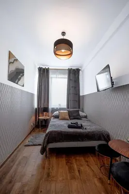 Łóżko lub łóżka w pokoju w obiekcie ClickTheFlat Wolska Apart Rooms