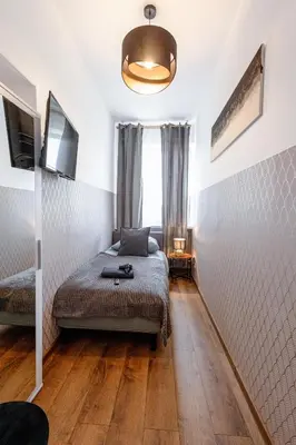 Łóżko lub łóżka w pokoju w obiekcie ClickTheFlat Wolska Apart Rooms