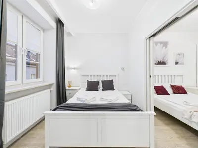 Łóżko lub łóżka w pokoju w obiekcie SuperApart Podwale 9 Unique, Step into Tranquility and Relaxation