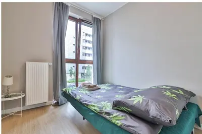 Łóżko lub łóżka w pokoju w obiekcie Airport Apartament Bokserska