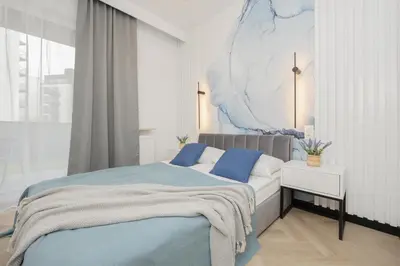 Łóżko lub łóżka w pokoju w obiekcie Przytulny Apartament z Parkingiem i Tarasem w Warszawie by Noclegi Renters
