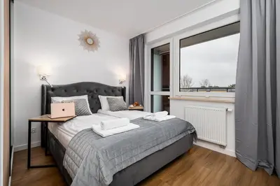 Łóżko lub łóżka w pokoju w obiekcie Pileckiego Residence